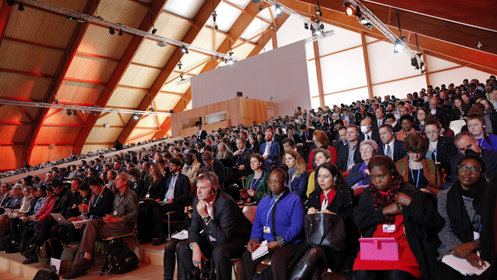 Participants attend a conference at the COP21, United Nations Climate Change Conference in Le Bourget, north of Paris, France, Thursday, Dec. 10, 2015. (AP Photo/Christophe Ena)