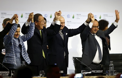 French President Francois Hollande, right, French Foreign Minister and president of the COP21 Laurent Fabius, second, right, United Nations climate chief Christiana Figueres and United Nations Secretary General Ban ki-Moon hold their hands up after the final conference at the COP21, the United Nations conference on climate change, in Le Bourget, north of Paris. (AP Photo/Francois Mori)