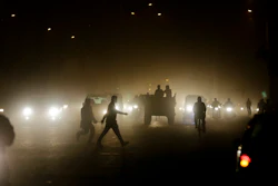 Pedestrians walk through a busy road in New Delhi, India. (AP Photo/Altaf Qadri)