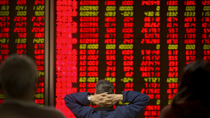 Chinese investors monitor stock prices in a brokerage house in Beijing, Friday, Jan. 8, 2016. (AP Photo/Mark Schiefelbein)