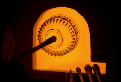 In this Friday, Jan. 22, 2016 photo, a glass bowl is fired in a furnace with techniques used by Renaissance Venetians at the Corning Museum of Glass in Corning, N.Y. Gudenrath spent decades researching how Renaissance-era glassmakers produced objects that are now considered works of art. (AP Photo/Mike Groll)