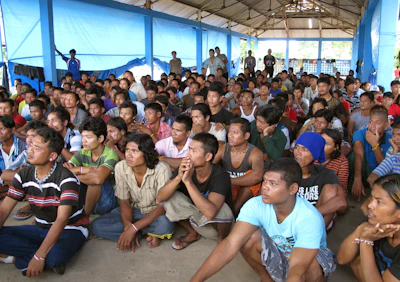 Former fishing slaves who were rescued by Indonesian government from the remote island of Benjina gather at their temporary shelter in Tual, Indonesia. (AP Photo/Margie Mason)