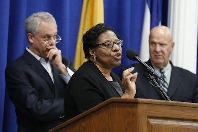 Valerie Wilson, center, school business administrator for the Newark Public Schools system, speaks at a news conference addressing the finding of lead levels earlier this month in Newark schools, Wednesday, March 9, 2016, in Newark, N.J. Standing with Wilson are Cristopher Cerf, left, Superintendent of Newark Public Schools, and Anthony Ambrose, acting director of public safety for Newark. (AP Photo/Julio Cortez)