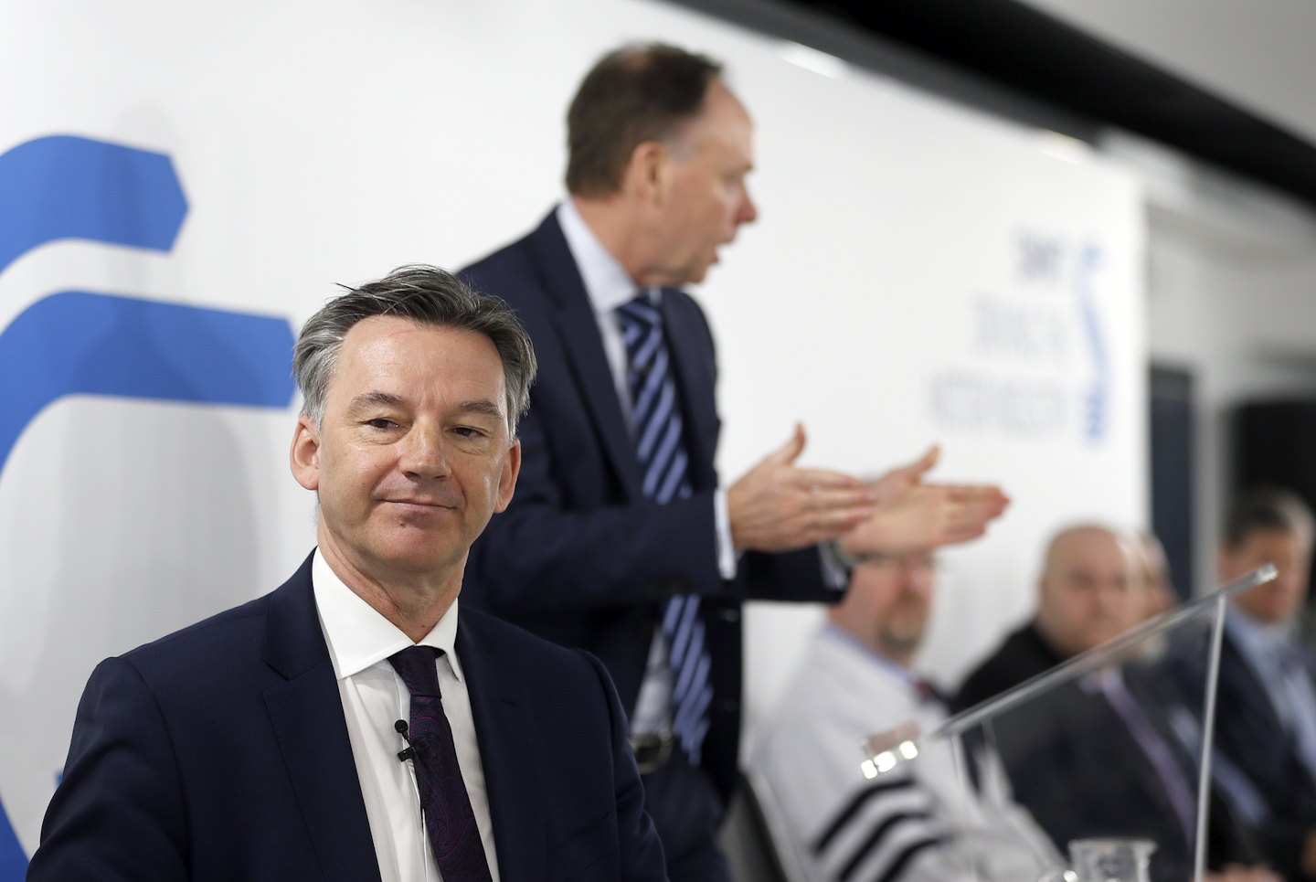Mike Hawes, SMMT Chief Executive, foreground, and Ian Robertson, member of the board of management at BMW, second left, during a press conference of the Society of Motor Manufacturers and Traders Limited (SMMT) UK automotive, focussing on Europe in London, Thursday, March 3, 2016. (AP Photo/Frank Augstein)