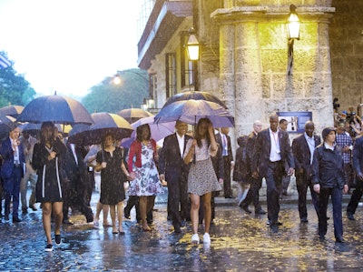 U.S. President Barack Obama, center, with his first lady Michelle Obama, daughters Malia and Sasha and first lady's mother Marian Robinson, take a walking tour of Old Havana in the rain, Sunday, March 20, 2016 in Havana, Cuba. Obama became the first U.S. president to visit the island in nearly 90 years. (AP Photo/Pablo Martinez Monsivais)