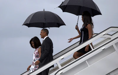 President Barack Obama, second from left, arrives with first lady Michelle Obama, left, and their daughters Sasha, front right, and Malia, as they exit Air Force One at the airport in Havana, Cuba, Sunday, March 20, 2016. Obama's trip is a crowning moment in his and Cuban President Raul Castro's ambitious effort to restore normal relations between their countries. (Cubadebate/Ismael Francisco via AP)