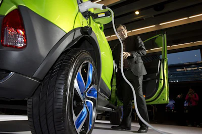 Michael Austin, BYD Co.'s vice president for the United States, introduces the latest plug in mini-SUV during the BYD Dreams Conference in Beijing, China. (AP Photo/Ng Han Guan)