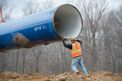In this March 17, 2016 file photo, laborers place a 50 foot section of the Karegnondi Water Authority pipeline near Oregon Twp, Mich. After months of national attention on lead-tainted drinking water in Flint, many are starting to ask questions about the 74-mile pipeline being built from Lake Huron to the struggling former auto manufacturing powerhouse. (David Guralnick /Detroit News via AP File)