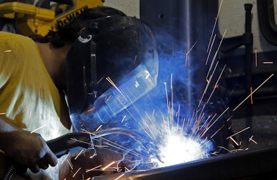 In this Monday, Sept. 14, 2015, file photo, welder Gabriel Gonzalez welds a support beam at a local welding shop in Hialeah, Fla. On Tuesday, May 17, 2016, the Federal Reserve reports on U.S. industrial production for April. (AP Photo/Alan Diaz, File)
