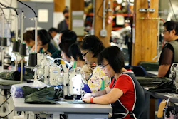 In this Wednesday, Aug. 31, 2016, file photo, a group of workers at the C.C. Filson Co. manufacturing facility work at their sewing machines, in Seattle. On Monday, Oct. 17, 2016, the Federal Reserve reports on U.S. industrial production for September. (AP Photo/Ted S. Warren, File)