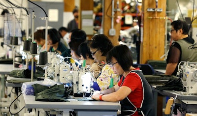 In this Wednesday, Aug. 31, 2016, file photo, a group of workers at the C.C. Filson Co. manufacturing facility work at their sewing machines, in Seattle. On Monday, Oct. 17, 2016, the Federal Reserve reports on U.S. industrial production for September. (AP Photo/Ted S. Warren, File)