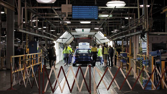 In this photo supplied by Ford Motor Co. Australia, Ford Motor Co. staff prepare the world's last six-cylinder, rear-wheel drive Falcon XR6, to roll off the assembly line at its Broadmeadows plant in Melbourne, Australia, Friday, Oct. 7, 2016. (Ford Motor Co. via AP)