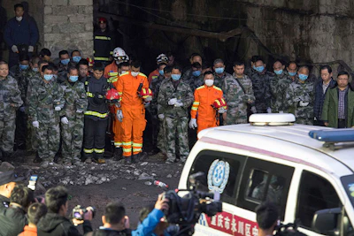 In this Tuesday, Nov. 1, 2016 photo released by Xinhua News Agency, rescuers mourn for victims at Jinshangou Coal Mine in Chongqing, southwest China. All the coal miners trapped underground in a gas explosion earlier this week have been found dead, state media reported Wednesday, as work safety officials vowed to punish those responsible. (Liu Chan/Xinhua via AP)