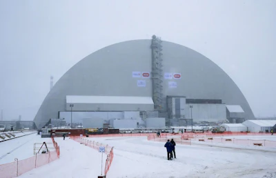 Workers inspect the New Safe Confinement (NSC) movable enclosure at the nuclear power plant in Chernobyl, Ukraine, Tuesday, Nov. 29, 2016. The NSC enclosure has slowly begun to move towards covering the Chernobyl nuclear reactor, in what represents a significant step toward liquidating the remains of the world's worst nuclear accident. (AP Photo/Efrem Lukatsky)