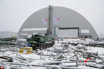 A view of the half-cylinder-shaped enclosure in Chernobyl, Ukraine, Tuesday, Nov. 29, 2016. A massive shelter has finally been installed over the exploded reactor at the Chernobyl nuclear plant, one of the most ambitious engineering projects in the world. The half-cylinder-shaped shelter began being moved toward the reactor on a system of hydraulic jacks two weeks ago and reached its destination Tuesday, a significant step toward liquidating the remains of the world's worst nuclear accident, 30 years ago in what is now Ukraine. (AP Photo/Efrem Lukatsky)