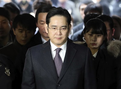In this Jan. 18, 2017, file photo, Lee Jae-yong, front, a vice chairman of Samsung Electronics Co. arrives for the hearing at the Seoul Central District Court in Seoul, South Korea. South Korean prosecutors say they will indict Lee on bribery, embezzlement and other charges linked to a political scandal that has toppled President Park Geun-hye. (AP Photo/Lee Jin-man, File)