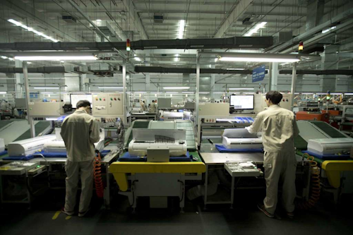 Factory workers assemble air conditioners on an assembly line at a Haier factory in Jiaozhou near Qingdao in eastern China's Shandong Province. (AP Photo)