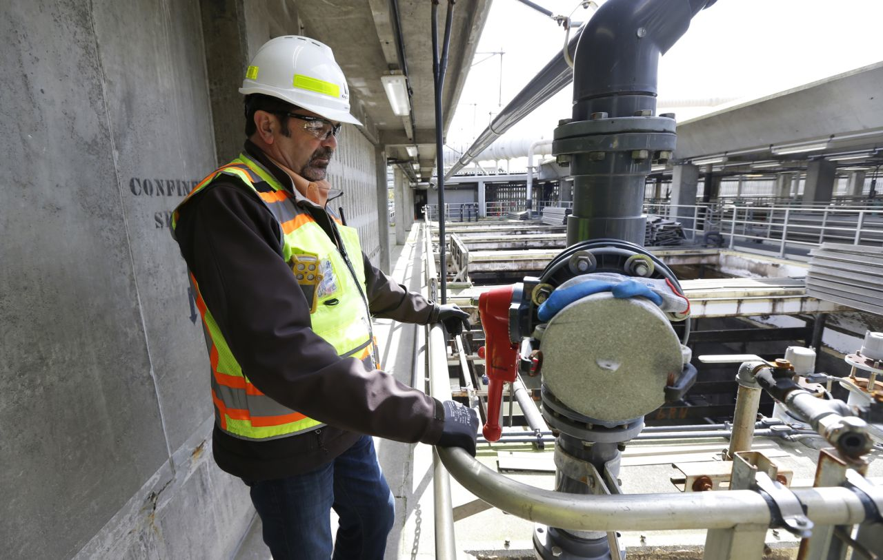 In this March 16, 2017 photo, Robert Waddle, division operations manager at the West Point Treatment Plant in Seattle, stands near a closed valve next to empty pools normally used to remove grit and other solids from sewage and storm water. The plant is still recovering from an equipment failure that crippled operations and caused millions of gallons of raw sewage and untreated runoff to pour into the United States' second largest estuary. (AP Photo/Ted S. Warren)