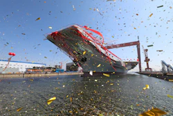 In this photo released by China's Xinhua News Agency, a newly-built aircraft carrier is transferred from dry dock into the water at a launch ceremony at a shipyard in Dalian in northeastern China's Liaoning Province, Wednesday, April 26, 2017. China launched its first aircraft carrier built entirely on its own on Wednesday, in a demonstration of the growing technical sophistication of its defense industries and determination to safeguard its maritime territorial claims and crucial trade routes. (Li Gang/Xinhua via AP)