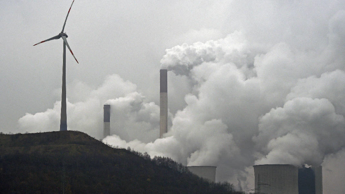 In this file photo dated Monday, Dec. 1, 2014, a wind turbine overlooks the coal-fired power station in Gelsenkirchen, Germany. The European Environment Agency released a report late Sunday July 9, 2017, saying coal-fired power plants are responsible for the most water and air pollution on the European continent, with Britain among the top polluters, followed by Germany, France and Poland. (AP Photo/Martin Meissner, FILE)