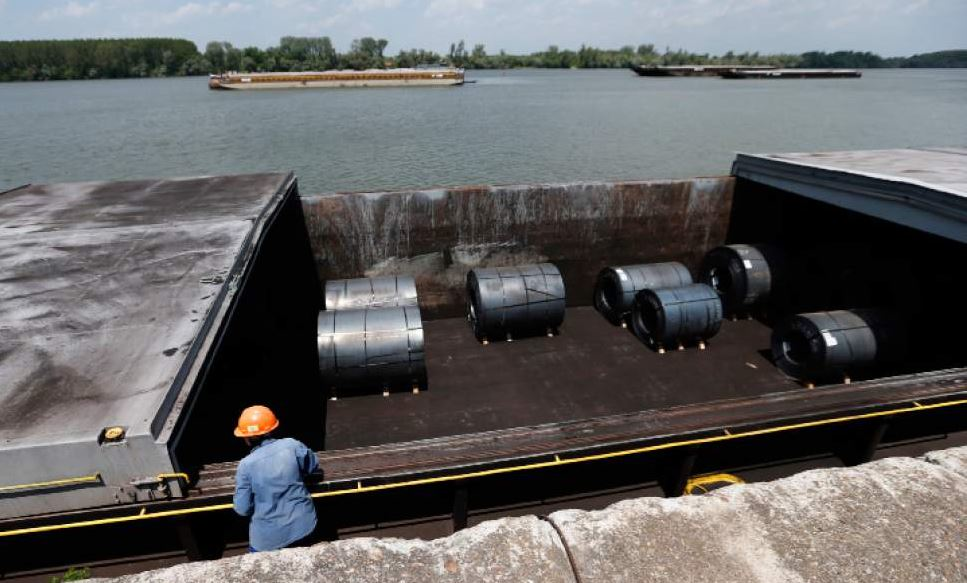 A worker inspects rolls of coiled steel plate in Smederevo, Serbia (AP photo)