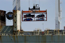 In this July 13, 2017 file photo, a crane transporting vehicles operates on a container ship at the Port of Oakland, in Oakland, Calif. A key draw for foreign assembly plants and investment has been Mexico's low wages. With many workers unable to afford the vehicles Mexico produces, the country exports about three times as many cars as are purchased domestically, most to the United States. (AP Photo/Ben Margot, File)