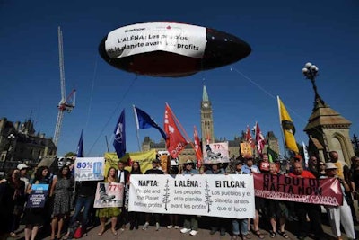 Anti-NAFTA supporters fly a blimp as they rally on Parliament Hill in Ottawa, Ontario, Friday, Sept. 22, 2017. The ISDS, or investor-state dispute settlement, is an arbitration system in which companies can sue nation-states. (Sean Kilpatrick/The Canadian Press via AP)