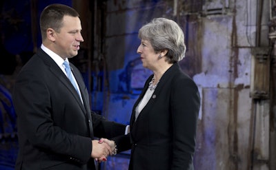 British Prime Minister Theresa May, right, is greeted by Estonian Prime Minister Juri Ratas during arrivals for an EU Digital Summit in Tallinn, Estonia on Friday, Sept. 29, 2017. The European Union is looking beyond its impending breakup with Britain at how to build a common future with the 27 nations remaining in the bloc. (AP Photo/Virginia Mayo)
