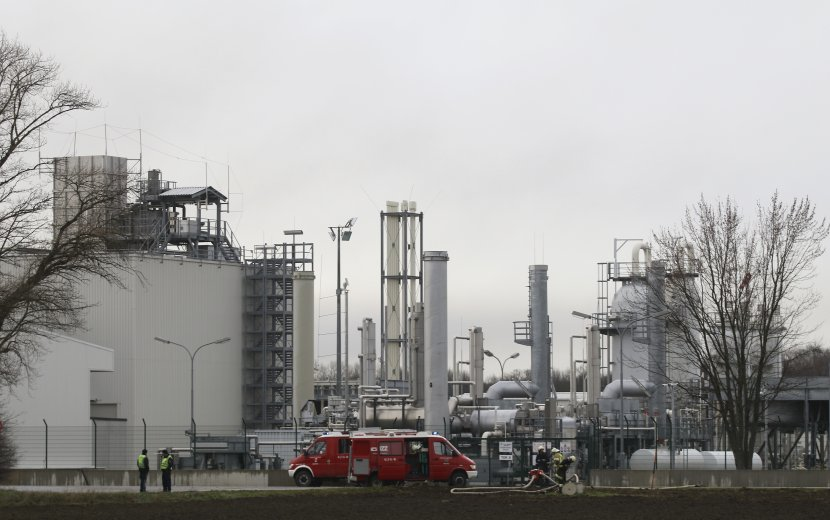 Firefighters stand outside a gas plant after an explosion occurred near Baumgarten an der March, Austria, Tuesday, Dec. 12, 2017. At least one person was killed and several were injured in the blast. (AP Photo/Ronald Zak)