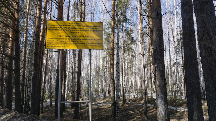 In this file photo taken on Friday April 8, 2016, a sign warns people not to enter the town of Ozersk, Chelyabinsk region, Russia, which houses the Mayak nuclear facility. Mayak is a nuclear complex that has been responsible for at least two of the country's biggest radioactive accidents. Russian authorities denied Friday that a radioactivity spike in the air over Europe resulted from a nuclear fuel plant leak in the Urals, saying their probe has found no release of radioactivity there. (AP Photo/Katherine Jacobsen, File)