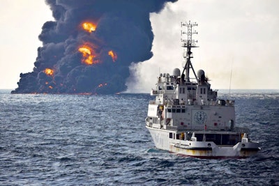 In this Sunday, Jan. 14, 2018, photo provided by China's Ministry of Transport, a rescue ship sails near the burning Iranian oil tanker Sanchi in the East China Sea off the eastern coast of China. The fire from the sunken Iranian tanker ship in the East China Sea has burned out, a Chinese transport ministry spokesman said Monday, although concerns remain about possible major pollution to the sea bed and surrounding waters. (Ministry of Transport via AP)