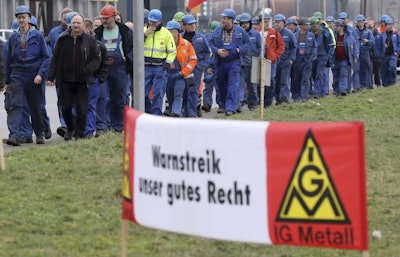Shipyard workers march during a warning strike at the Baltic Sea harbor of Rostock, eastern Germany, Wednesday, Jan. 24, 2018. Germany’s largest industrial union says tens of thousands of factory workers have staged short-term warning strikes to increase pressure on employers amid wage negotiations.Banner reads: We have the right to strike. (Bernd Wuestneck/dpa via AP)