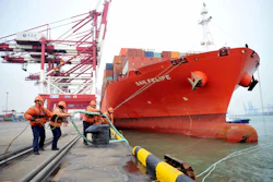 Chinese border police officers watch the arrival of a container ship at a port in Qingdao in eastern China's Shandong province, Thursday, March 8, 2018. Image credit: Chinatopix via AP