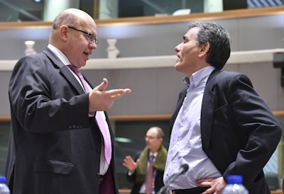 Germany's acting chief of finance Peter Altmaier, left, speaks with Greek Finance Minister Euclid Tsakalotos during a meeting of the eurogroup at the EU Council building in Brussels on Monday, March 12, 2018. Image credit: AP Photo/Geert Vanden Wijngaert
