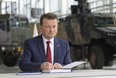 Polish Defense Minister Mariusz Blaszczak signs a deal to buy the U.S. made air defense Patriot system in Warsaw, Poland, Wednesday, March 28, 2018. Image credit: AP Photo/Alik Keplicz