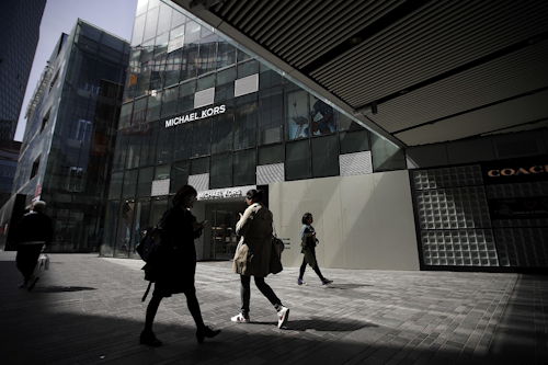 Chinese people walk through the capital city's popular shopping mall in Beijing, Tuesday, April 10, 2018. Image credit: AP Photo/Andy Wong