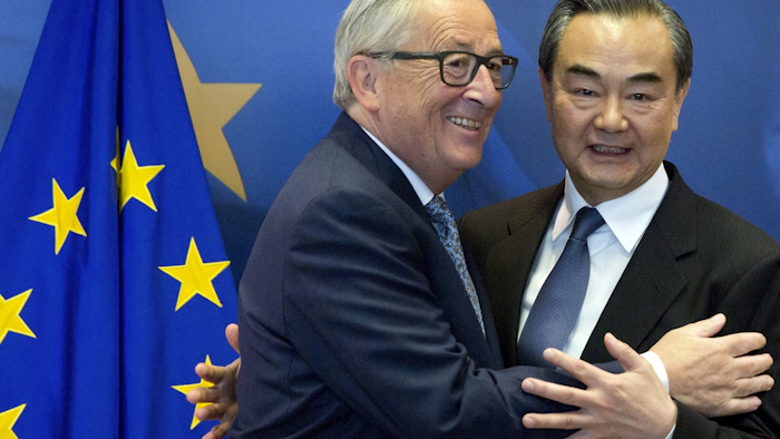 European Commission President Jean-Claude Juncker, left, prepares to shake hands with China's Foreign Minister Wang Yi prior to a meeting at EU headquarters in Brussels, Friday, June 1, 2018. Image credit: AP Photo/Virginia Mayo
