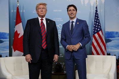 In this June 8, 2018 file photo, U.S. President Donald Trump meets with Canadian Prime Minister Justin Trudeau at the G-7 summit in Charlevoix, Canada. Image credit: AP Photo/Evan Vucci, File