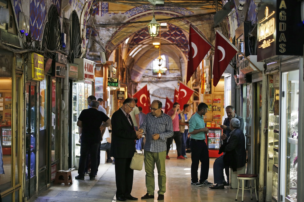 In this Wednesday, May 23, 2018 file photo, people change foreign currency in a market in Istanbul. Image credit: AP Photo/Lefteris Pitarakis, File