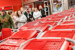 In this Friday, Nov. 23, 2018, file photo, shoppers enter and take their shopping carts during a Black Friday sale at a Target store in Newport, Ky. Image credit: AP Photo/John Minchillo, File