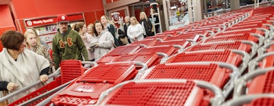 In this Friday, Nov. 23, 2018, file photo, shoppers enter and take their shopping carts during a Black Friday sale at a Target store in Newport, Ky. Image credit: AP Photo/John Minchillo, File