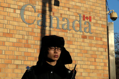 A policeman stands watch outside the Canadian Embassy in Beijing, Wednesday, Dec. 12, 2018. Image credit: AP Photo/Andy Wong