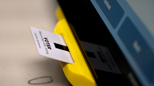 In this Nov. 5, 2019 file photo, an electronic card with ballot information is seen inserted in a voting machine in Dallas, GA.