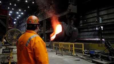 In this June 28, 2018 file photo, senior melt operator Randy Feltmeyer watches a giant ladle as it backs away after pouring its contents of red-hot iron into a vessel in the basic oxygen furnace as part of the process of producing steel at the U.S. Steel Granite City Works facility in Granite City, IL.