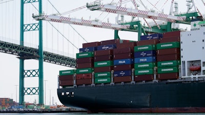 In this June 19, 2019 file photo, a cargo ship is docked at the Port of Los Angeles in Los Angeles.