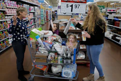 In this Nov. 27, 2019 file photo, from left, Tina Fausto, left, and Olivia Wirtshafter, right, shop with Lilly Flores, second from left, and Laly Rose Stanton the day before the Thanksgiving holiday at a Walmart Supercenter in Las Vegas.