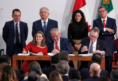 Deputy Prime Minister of Canada Chrystia Freeland, left, Mexico's top trade negotiator Jesus Seade, center, and U.S. Trade Representative Robert Lighthizer, sign an update to the North American Free Trade Agreement, at the national palace in Mexico City on Tuesday, Dec. 10. Observing from behind are Mexico's Treasury Secretary Arturo Herrera, left, Mexico's President Andres Manuel Lopez Obrador, second left, Mexico's Labor Secretary Maria Alcade, third left, and The President of the Mexican Senate Ricardo Monreal.