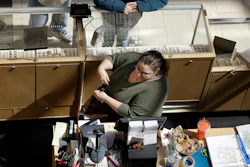 In this April 9, 2018 file photo a cashier rings up a purchase at a store in Salem, NH.