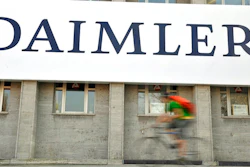 In this April 8, 2009 file photo, a cyclist passes a logo of German car company Daimler in Berlin. German automaker Daimler said Friday, Nov. 29, 2019 that it plans to cut at least 10,000 jobs worldwide by the end of 2022. The company had said Nov. 14 that it plans to slash costs by 1.4 billion euros ($1.54 billion) by cutting every tenth managerial position and through other measures, but didn’t give details.