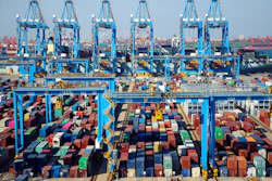 In this Thursday, Nov. 28, 2019, photo, trucks load containers at the automated container dockyard in Qingdao in east China's Shandong province. A Chinese official newspaper has reiterated, repeatedly, Beijing's demand that the U.S. roll back tariffs imposed by President Donald Trump's administration in exchange for a deal. The Communist Party newspaper Global Times ran several articles Monday, Dec. 2, 2019 that emphasized there would be no deal without a promise to phase out the tariffs imposed by Washington.
